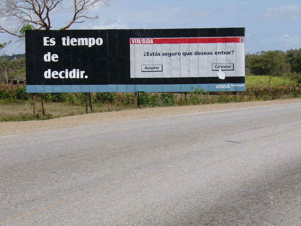Auch AIDS-Warnungen werden per Plakat gemacht. Text auf dem Plakat: 'Es ist Zeit zu entscheiden'. Dialogtitel: 'HIV/AIDS' Frage: 'Bist Du sicher, dass Du eintreten willst?'