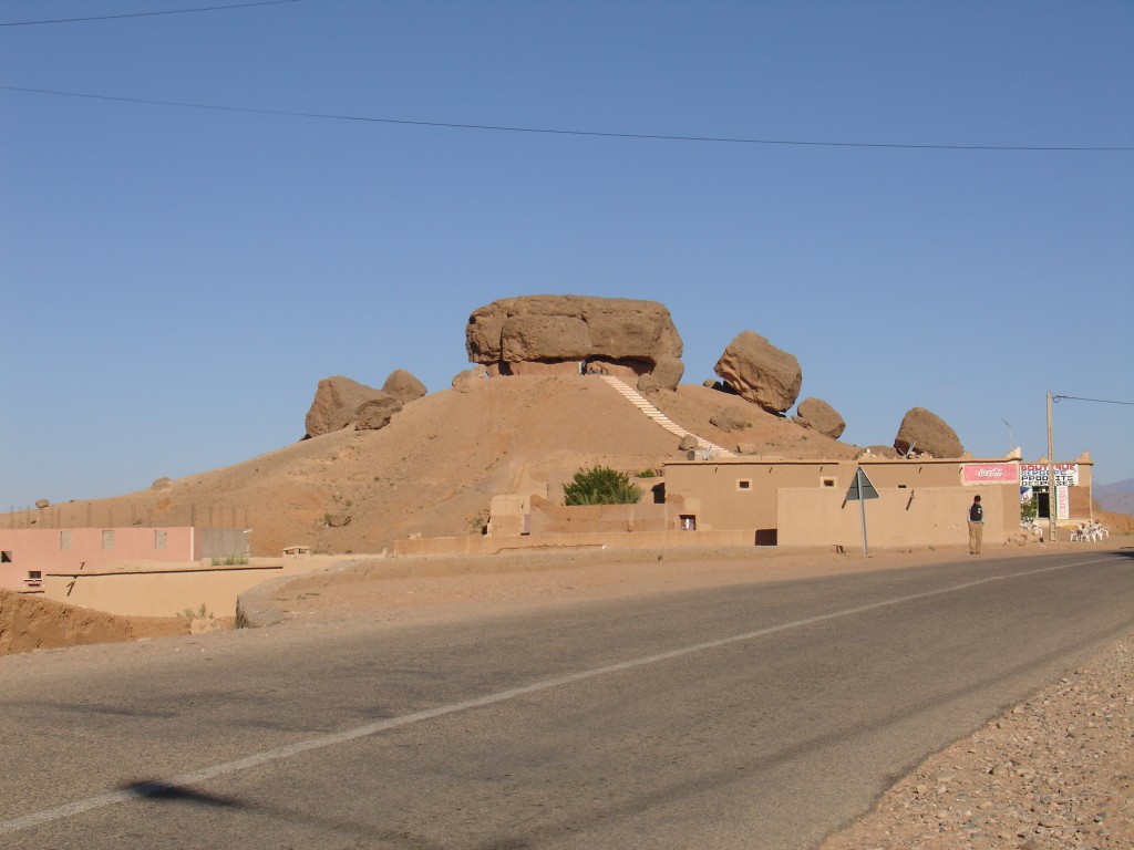 Auf einem Sandhügel neben der Straße lagen einige große Felsen.