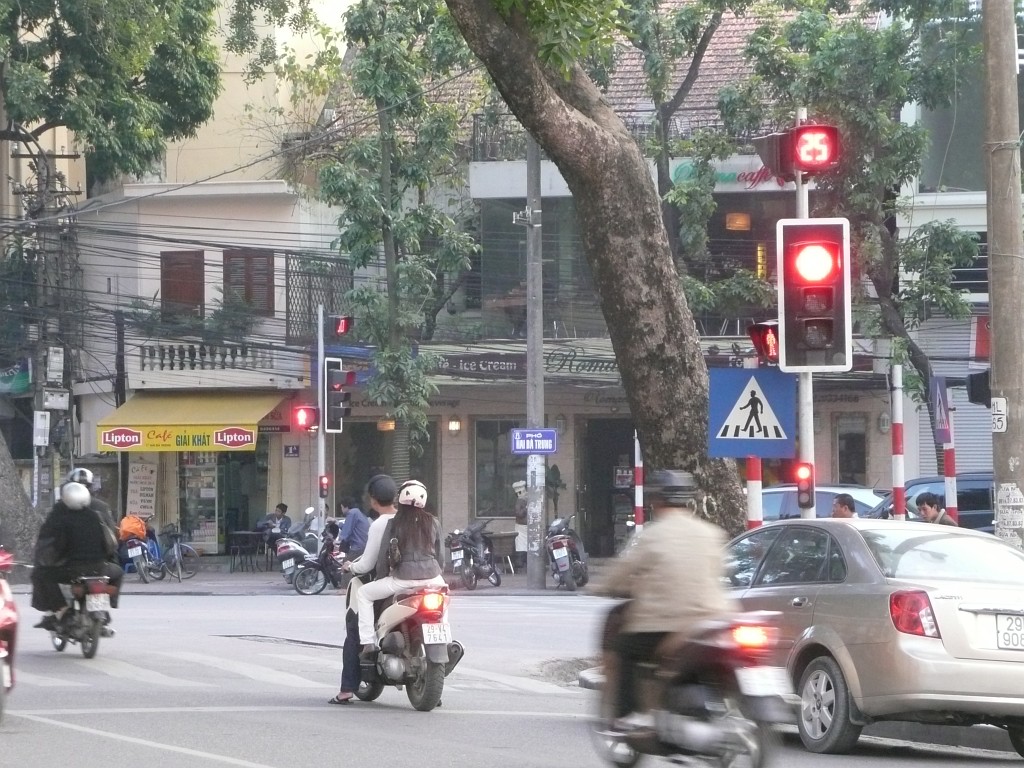 Erst seit wenigen Jahren gibt es in Hanoi viele Ampeln an den Kreuzungen, dafür sind die aber sehr modern: Oberhalb der Ampel zählen rote Ziffern herunter, wieviele Sekunden es noch rot ist, und anschließend grüne Ziffern, wie lange es noch grün bleiben wird.
